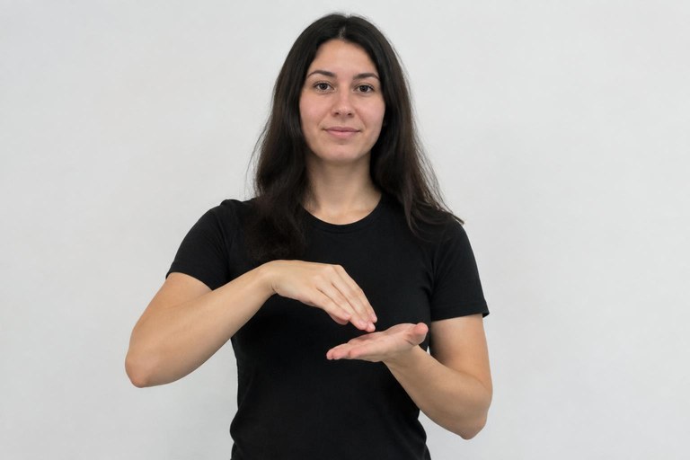 The back of one hand taps the open palm for the sign MONEY