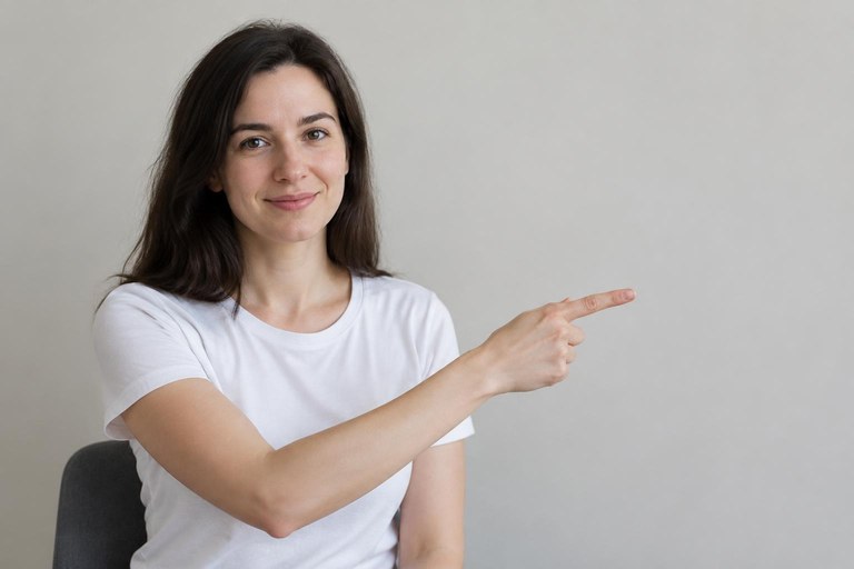 A signer points to an empty spot in the air to their right to establish a referent