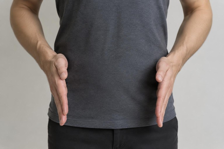 Both flat hands facing each other slide downward to form the person marker